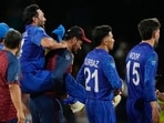 Afghanistan's Gulbadin Naib is carried from the field as he celebrates with teammates after defeating Australia.