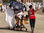 Medical team members evacuate a Muslim pilgrim, affected by the soarching heat, at the base of Mount Arafat during the annual hajj pilgrimage Medical team members evacuate a Muslim pilgrim, affected by the soarching heat, at the base of Mount Arafat during the annual hajj pilgrimage
