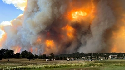 In this photo provided by Pam Bonner, smoke rises from fires in Ruidoso, N.M., Monday, June 17, 2024. Thousands of southern New Mexico residents fled the mountainous village as a wind-whipped wildfire tore through homes and other buildings. (Pam Bonner via AP) (AP) In this photo provided by Pam Bonner, smoke rises from fires in Ruidoso, N.M., Monday, June 17, 2024. Thousands of southern New Mexico residents fled the mountainous village as a wind-whipped wildfire tore through homes and other buildings. (Pam Bonner via AP) (AP)