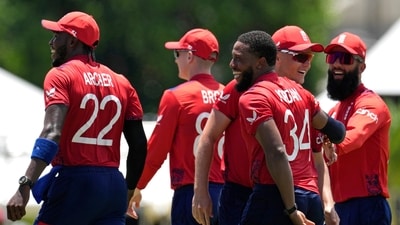 England's Chris Jordan, third right without cap, celebrates with teammates after getting a hat-trick by dismissing United States' Saurabh Netralvakar (PTI) England's Chris Jordan, third right without cap, celebrates with teammates after getting a hat-trick by dismissing United States' Saurabh Netralvakar (PTI)