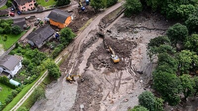 This aerial photograph shows diggers clearing an area in the Graubunden (Grisons) canton in Switzerland after violent downpours caused floods and landslides (AFP)