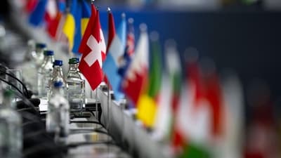 This photograph shows the Swiss flag sets among the flags of the other countries during a plenary session at the Summit on peace in Ukraine, at the luxury Burgenstock resort, near Lucerne, on June 16, 2024. The two-day gathering brings together Ukrainian President and more than 50 other heads of state and government, to try to work out a way towards a peace process for Ukraine -- albeit without Russia. (Photo by URS FLUEELER / POOL / AFP) (AFP) This photograph shows the Swiss flag sets among the flags of the other countries during a plenary session at the Summit on peace in Ukraine, at the luxury Burgenstock resort, near Lucerne, on June 16, 2024. The two-day gathering brings together Ukrainian President and more than 50 other heads of state and government, to try to work out a way towards a peace process for Ukraine -- albeit without Russia. (Photo by URS FLUEELER / POOL / AFP) (AFP)