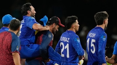 Afghanistan's Gulbadin Naib is carried from the field as he celebrates with teammates after defeating Australia. (AP)