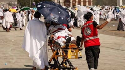 Medical team members evacuate a Muslim pilgrim, affected by the soarching heat, at the base of Mount Arafat during the annual hajj pilgrimage (AFP) Medical team members evacuate a Muslim pilgrim, affected by the soarching heat, at the base of Mount Arafat during the annual hajj pilgrimage (AFP)
