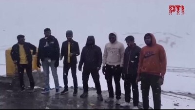 Locals and tourists are seen celebrating the unexpected weather event after a hot summer. (PTI) Locals and tourists are seen celebrating the unexpected weather event after a hot summer. (PTI)
