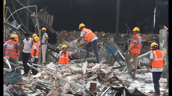 Members of the Haryana State Disaster Response Force (SDRF), firefighters and police personnel conduct a search and rescue operation at the blast site in Daulatabad Industrial Area near the Dwarka Expressway on Saturday. (Parveen Kumar/HT PHOTO)