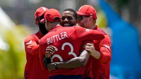 England's Chris Jordan, second right, celebrates with teammates after getting a hat-trick by dismissing United States' Saurabh Nethralvakar (AP)