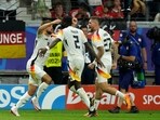 Germany's Niclas Fuellkrug, left, celebrates with teammates after scoring his side's first goal during a Group A match between Switzerland and Germany at the Euro 2024 soccer tournament in Frankfurt, Germany, Sunday,