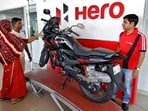 Customers look at a Hero MotoCorp Karizma motorbike at a Hero MotoCorp showroom.