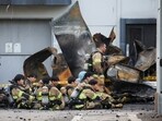 Firefighters take a break as rescue work continues following a deadly fire at a lithium battery factory owned by South Korean battery maker Aricell, in Hwaseong, South Korea