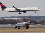 An American Airlines aircraft taxis as a Delta Air Lines aircraft lands at Reagan National Airport in Arlington, Virginia, U.S. REUTERS/Joshua Roberts/File Photo
