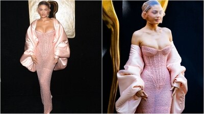 Kylie Jenner made a stunning entrance in Paris for the Schiaparelli show at Couture Week, adorned in a mesmerising pink gown featuring a sweetheart neckline and a corseted bodice embellished with crystals. Her ensemble was complemented by a voluminous silk cape and a sheer mask veiling her face, solidifying her status as the talk of the fashion world. It's Kylie Jenner—expect nothing less than extraordinary. (Instagram)