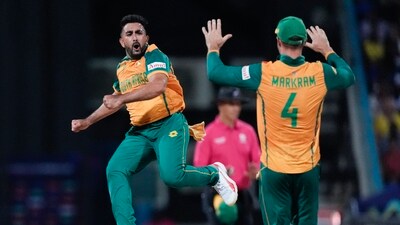 South Africa's Tabraiz Shamsi celebrates with teammate Aiden Markram after taking the wicket West Indies' Sherfane Rutherford during the ICC Men's T20 World Cup cricket match between the West Indies and South Africa at Sir Vivian Richards Stadium in North Sound, Antigua and Barbuda, Sunday, June 23, 2024. AP/PTI(AP06_24_2024_000010A) (AP) South Africa's Tabraiz Shamsi celebrates with teammate Aiden Markram after taking the wicket West Indies' Sherfane Rutherford during the ICC Men's T20 World Cup cricket match between the West Indies and South Africa at Sir Vivian Richards Stadium in North Sound, Antigua and Barbuda, Sunday, June 23, 2024. AP/PTI(AP06_24_2024_000010A) (AP)