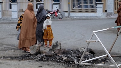 Women and children look at a spot where a Muslim mob lynched and burned a man over allegations that he had desecrated Islam's holy book,  the Quran, in Madyan in Pakistan's Khyber Pakhtunkhwa province, Friday, June 21, 2024. The attackers also torched a police station which had held the man in Madyan and burned police vehicles parked there, according to local police official Rahim Ullah. (AP Photo/Naveed Ali) (AP)