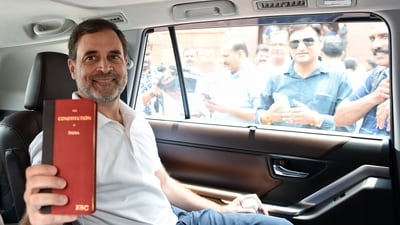 Congress leader and Rae Bareli MP Rahul Gandhi arrives with a copy of the Indian Constitution that he widely used during his 2024 Lok Sabha election campaign. (ANI)
