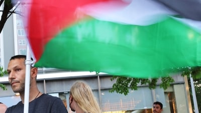 A person holds a Palestine flag as people participate in a 'Climate Justice Means Free Palestine!' rally outside of the Citibank headquarters on June 18, 2024 in New York City. Michael M. Santiago/Getty Images/AFP (Photo by Michael M. Santiago / GETTY IMAGES NORTH AMERICA / Getty Images via AFP) (Getty Images via AFP) A person holds a Palestine flag as people participate in a 'Climate Justice Means Free Palestine!' rally outside of the Citibank headquarters on June 18, 2024 in New York City. Michael M. Santiago/Getty Images/AFP (Photo by Michael M. Santiago / GETTY IMAGES NORTH AMERICA / Getty Images via AFP) (Getty Images via AFP)