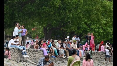 Visitors enjoying the pleasant weather at Sukhna Lake in Chandigarh on Monday.   (Ravi Kumar/HT)