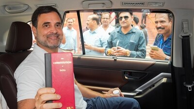 Congress member Rahul Gandhi shows a book of Constitution of India at the Parliament House complex on the first day of the first session of the 18th Lok Sabha, in New Delhi, Monday, June 24, 2024. (PTI)