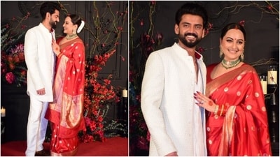 Newlyweds Sonakshi and Zaheer chose traditional ensembles for the reception party. The bride donned a sindoori red brocade silk saree and a matching blouse for the occasion, styled with emerald and gold earrings and a choker necklace. Zaheer complemented her in a white embroidered bandhgala jacket, matching short kurta and pants. (HT Photo/Varinder Chawla) Newlyweds Sonakshi and Zaheer chose traditional ensembles for the reception party. The bride donned a sindoori red brocade silk saree and a matching blouse for the occasion, styled with emerald and gold earrings and a choker necklace. Zaheer complemented her in a white embroidered bandhgala jacket, matching short kurta and pants. (HT Photo/Varinder Chawla)
