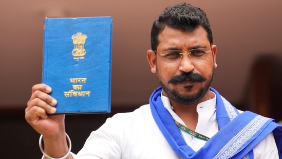 Azad Samaj Party (Kanshi Ram) chief and MP elect from UP's Nagina Chandrashekar Azad arrives with a copy of Indian Constitution.(PTI)