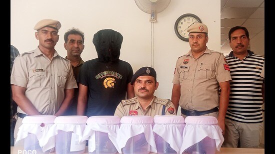Assistant commissioner of police Arvind Kamboj giving details about the arrest during a press conference in Panchkula on Monday. (Sant Arora/HT)
