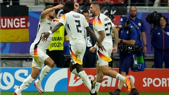 Germany's Niclas Fuellkrug, left, celebrates with teammates after scoring his side's first goal during a Group A match between Switzerland and Germany at the Euro 2024 soccer tournament in Frankfurt, Germany, Sunday, (AP)