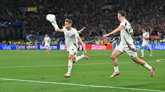 Hungary's forward #23 Kevin Csoboth (L) celebrates with teammates after scoring his team's first goal (AFP)