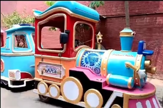 The toy train that has three compartments. Shahbaz was riding the third coach.