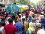 People gather near a water tanker to fill water as the water crisis continues in the National Capital, at Sanjay Colony, Okhla, in New Delhi on Saturday (ANI)
