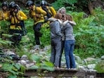 In this photo provided by SLV Steve, lost hiker Lukas McClish, 34, is reunited with his family on Thursday, June 20, 2024, in the rural community of Boulder Creek, Calif. McClish, who went missing for 10 days, was found safe in the mountains in Northern California, authorities said. (SLV Steve via AP)