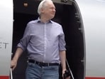 WikiLeaks founder Julian Assange disembarks from a plane at Bangkok Don Mueang International Airport, 