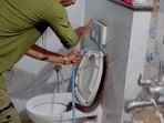 A cobra was found inside a commode in Indore, Madhya Pradesh,(Instagram/@rajesh_indori_snake_rescuer_)