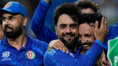 Afghanistan's captain Rashid Khan, centre, embraces teammate Gulbadin Naib as they celebrate after defeating Bangladesh by eight runs in their men's T20 World Cup cricket match at Arnos Vale Ground, Kingstown, Saint Vincent (AP) Afghanistan's captain Rashid Khan, centre, embraces teammate Gulbadin Naib as they celebrate after defeating Bangladesh by eight runs in their men's T20 World Cup cricket match at Arnos Vale Ground, Kingstown, Saint Vincent (AP)