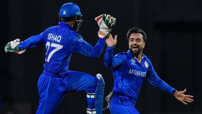 Afghanistan's captain Rashid Khan (R) and Afghanistan's Mohammad Ishaq celebrate the dismissal of Bangladesh's Rishad Hossain during the ICC men's Twenty20 World Cup 2024 Super Eight cricket match between Afghanistan and Bangladesh at Arnos Vale Stadium in Arnos Vale, Saint Vincent and the Grenadines on June 24, 2024. (Photo by Randy Brooks / AFP) (AFP) Afghanistan's captain Rashid Khan (R) and Afghanistan's Mohammad Ishaq celebrate the dismissal of Bangladesh's Rishad Hossain during the ICC men's Twenty20 World Cup 2024 Super Eight cricket match between Afghanistan and Bangladesh at Arnos Vale Stadium in Arnos Vale, Saint Vincent and the Grenadines on June 24, 2024. (Photo by Randy Brooks / AFP) (AFP)