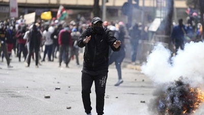 Protesters scatter as police fire tear gas at them during a protest over proposed tax hikes in a finance bill in downtown Nairobi, Kenya Tuesday, June. 25, 2024. (AP Photo/Brian Inganga) Protesters scatter as police fire tear gas at them during a protest over proposed tax hikes in a finance bill in downtown Nairobi, Kenya Tuesday, June. 25, 2024. (AP Photo/Brian Inganga)