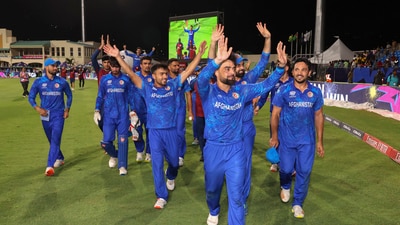 Afghanistan's captain Rashid Khan with teammates acknowledges fans after Afghanistan won the ICC Men's T20 World Cup cricket match against Bangladesh, at Arnos Vale Ground, Kingstown, Saint Vincent and the Grenadines (PTI) Afghanistan's captain Rashid Khan with teammates acknowledges fans after Afghanistan won the ICC Men's T20 World Cup cricket match against Bangladesh, at Arnos Vale Ground, Kingstown, Saint Vincent and the Grenadines (PTI)