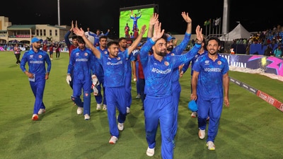 Afghanistan's captain Rashid Khan, with teammates, acknowledges fans after advancing to the ICC Men's T20 World Cup semis by beating Bangladesh (PTI) Afghanistan's captain Rashid Khan, with teammates, acknowledges fans after advancing to the ICC Men's T20 World Cup semis by beating Bangladesh (PTI)