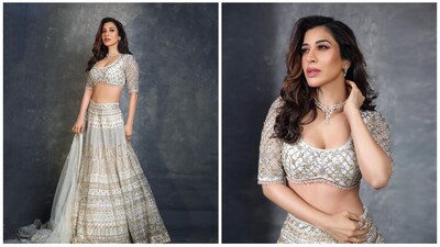 Sophie Choudry shared pictures of herself in a stunning ivory lehenga with gold embroidery. She paired it with a diamond necklace and styled her hair in loose curls. The lehenga was by Ruchika Hurria. 