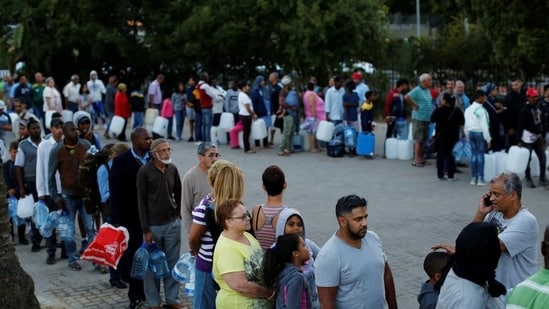 In February 2018, people queuing up to collect water from a spring in the Newlands suburb as the city's water crisis grows in Cape Town, South Africa. (Reuters file)