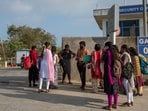 Job aspirants talk with a hiring agent outside the Foxconn factory, where workers assemble iPhones for Apple, in Sriperumbudur, near Chennai, India, (Palani Kumar/Reuters)