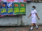 A woman walks past posters pasted on a roadside wall saying 'good news' in Sinhala language, in Colombo on June 25, 2024, as President Ranil Wickremesinghe is expected to announce a debt restructure deal with bilateral lenders after a sovereign default in April 2022. (Ishara S.Kodikara / AFP) A woman walks past posters pasted on a roadside wall saying 'good news' in Sinhala language, in Colombo on June 25, 2024, as President Ranil Wickremesinghe is expected to announce a debt restructure deal with bilateral lenders after a sovereign default in April 2022. (Ishara S.Kodikara / AFP)
