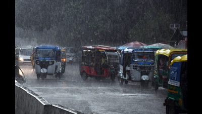 Commuters pass on a road during rain in Kanpur on Wednesday. (ANI) Commuters pass on a road during rain in Kanpur on Wednesday. (ANI)