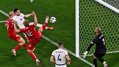 Denmark's Victor Kristiansen, left, and Kasper Dolberg (12) and Serbia's Andrija Zivkovic (14) challenge for the ball during a Group C match between Denmark and Serbia at the Euro 2024 soccer tournament in Munich (AP) Denmark's Victor Kristiansen, left, and Kasper Dolberg (12) and Serbia's Andrija Zivkovic (14) challenge for the ball during a Group C match between Denmark and Serbia at the Euro 2024 soccer tournament in Munich (AP)