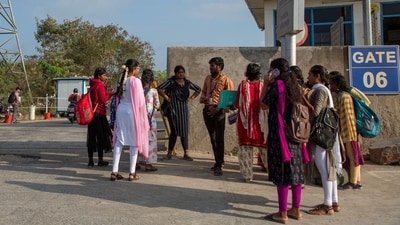 Job aspirants talk with a hiring agent outside the Foxconn factory, where workers assemble iPhones for Apple, in Sriperumbudur, near Chennai, India, (Palani Kumar/Reuters)