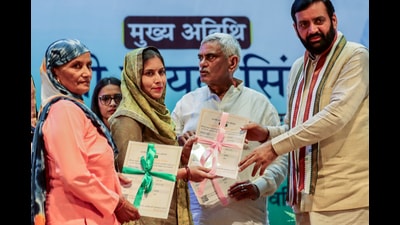 Haryana Chief Minister Nayab Singh Saini hands over allotment letters of 30 square-yard plots to Antyodaya beneficiaries, in Rohtak on Wednesday. (ANI) Haryana Chief Minister Nayab Singh Saini hands over allotment letters of 30 square-yard plots to Antyodaya beneficiaries, in Rohtak on Wednesday. (ANI)