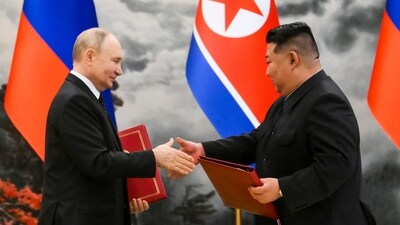 Russian President Vladimir Putin, left, and North Korea's leader Kim Jong Un exchange documents during a signing ceremony of the new partnership (AP)