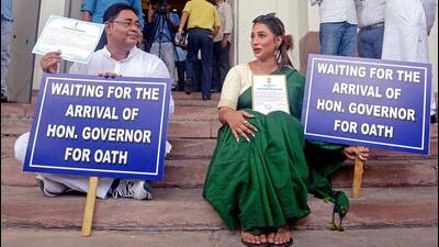 Newly elected TMC MLAs Sayantika Bandyopadhyay and Rayat Hossain Sarkar holding placards sitting on the stairs of the legislative assembly on Wednesday. (ANI) Newly elected TMC MLAs Sayantika Bandyopadhyay and Rayat Hossain Sarkar holding placards sitting on the stairs of the legislative assembly on Wednesday. (ANI)