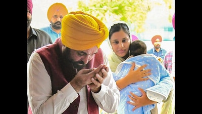 Punjab chief minister Bhagwant Singh Mann performs rituals while entering his rented house with his family in Jalandhar. (PTI)