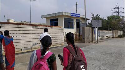 Two unidentified women wearing backpacks stand outside a security office at the main entrance to Foxconn's factory in Sriperumbudur, near Chennai, where workers assemble iPhones for Apple. (REUTERS) Two unidentified women wearing backpacks stand outside a security office at the main entrance to Foxconn's factory in Sriperumbudur, near Chennai, where workers assemble iPhones for Apple. (REUTERS)