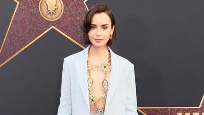 Emily in Paris star Lilly Collins attends the premiere in a body chain that she paired with a pastel blue jacket. Emily in Paris star Lilly Collins attends the premiere in a body chain that she paired with a pastel blue jacket.